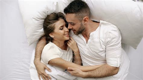 Young Couple Hugging and Caressing in Bed